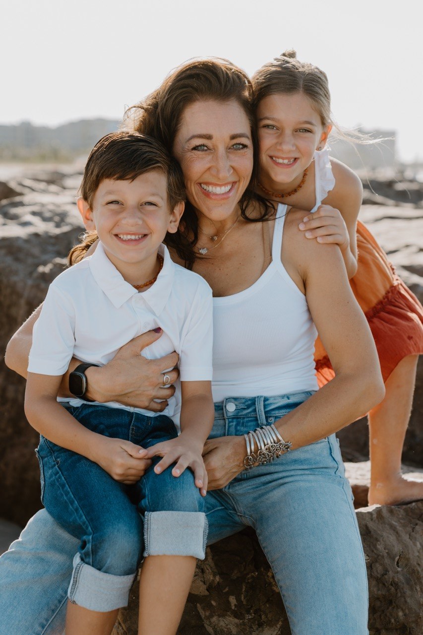 Doctor smiling with two children outdoors